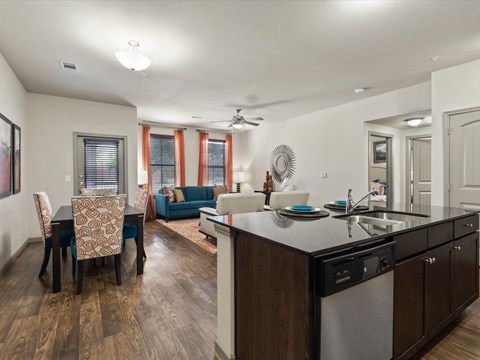 a living room with a kitchen and a dining room