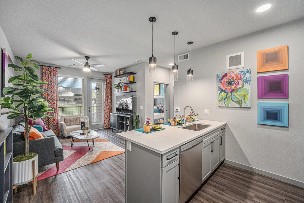 Kitchen with a view of the living room and white walls