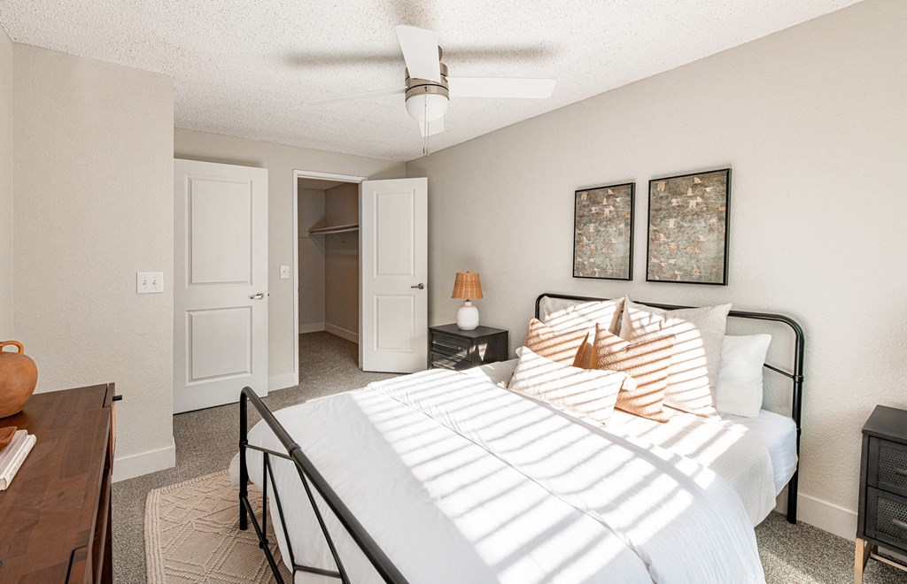 a bedroom with a large bed and a closet