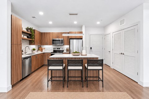 A modern kitchen with a dining table and chairs.