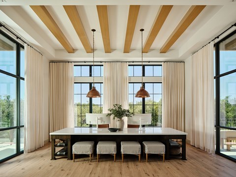 A dining room with a long table and chairs.