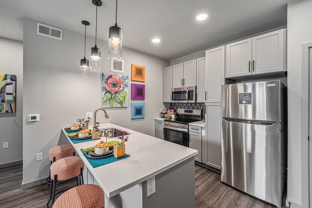 Kitchen with stainless steel appliances and barstools