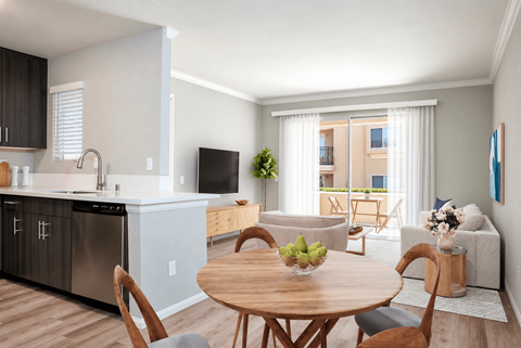 A modern kitchen with a dining table and chairs.