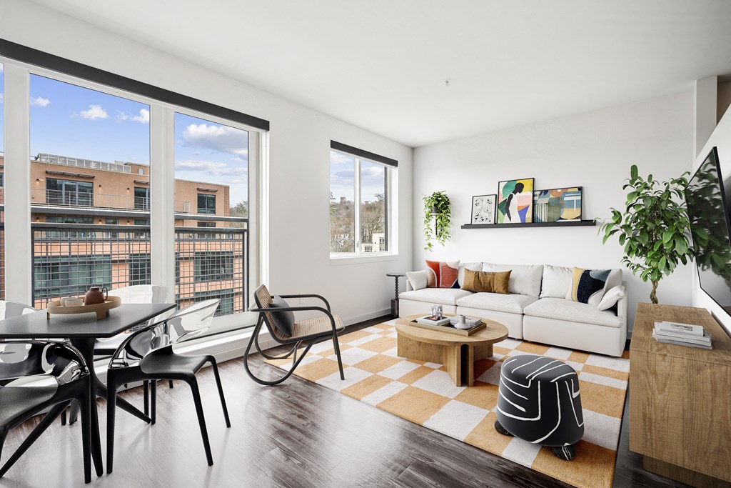 a living room with a couch and a table and a large window