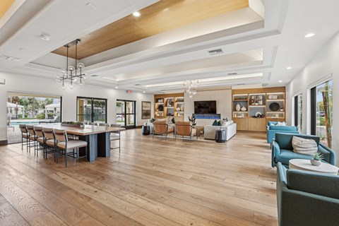 A spacious living room with a dining table and chairs.