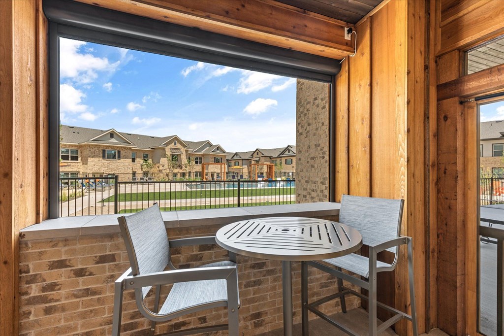a patio with a table and two chairs