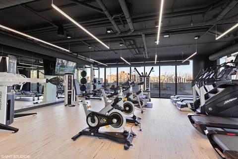 A gym with a variety of exercise equipment.