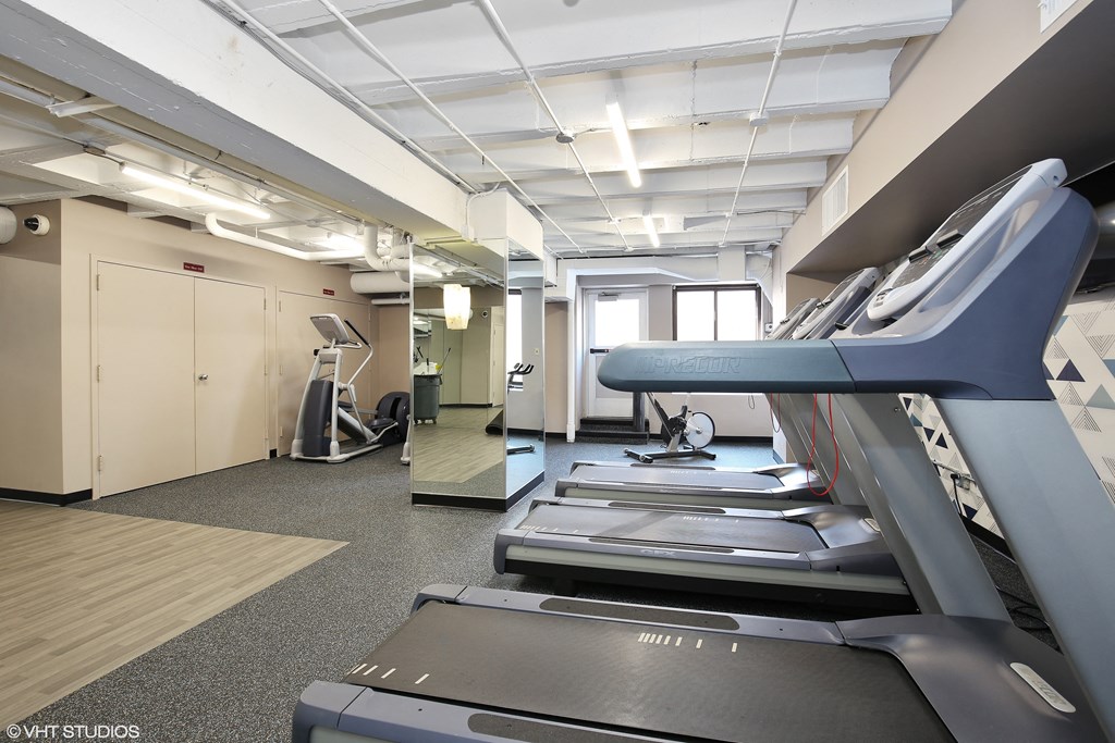 a gym with treadmills and other exercise equipment