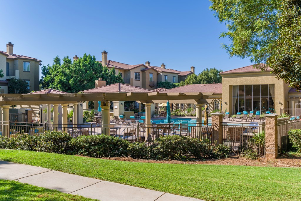 A sunny day at the poolside with a clear blue sky.