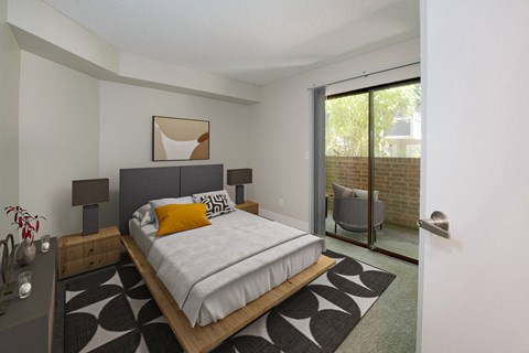 A bedroom with a bed, nightstand, and chair.