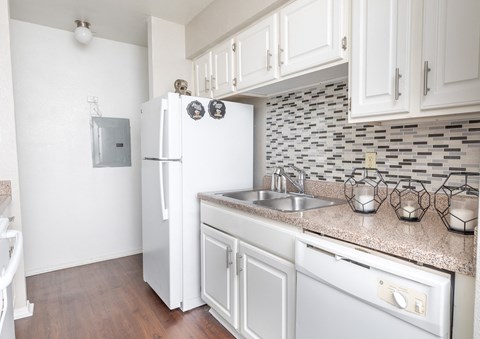 A kitchen with a white fridge and a white oven.