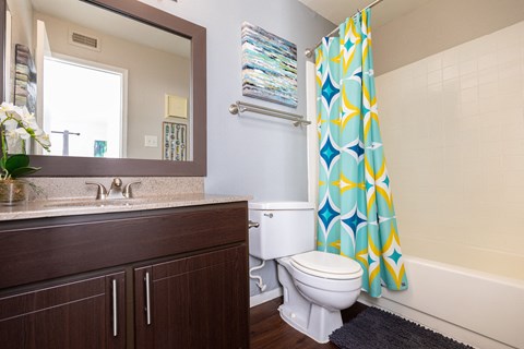 A bathroom with a toilet, sink, and shower.