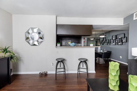 A modern living room with a bar area and a television.
