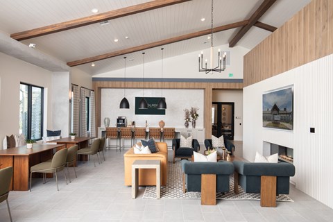 A modern living room with a dining area and a fireplace.