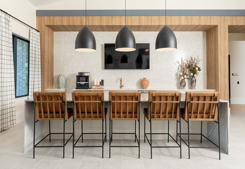 A modern dining room with a wooden table and chairs.