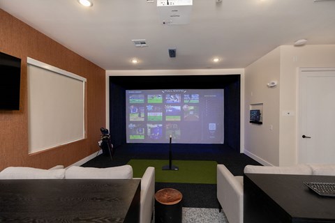 A conference room with a large screen at the front.