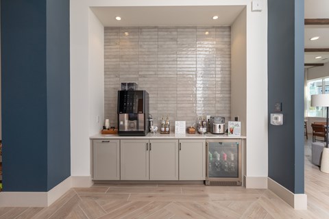 A kitchen area with a glass display cabinet containing various items.