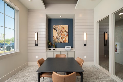 A dining room with a table and chairs.