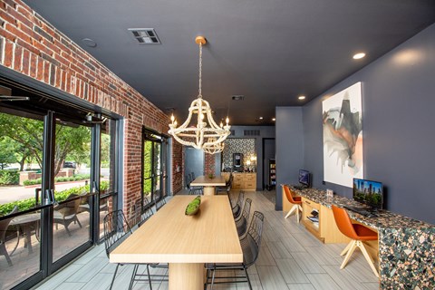 A modern dining room with a wooden table and chairs.