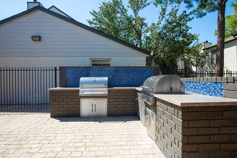 A backyard with a grill and a pool table.