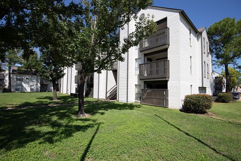 A white building with a balcony on the second floor.