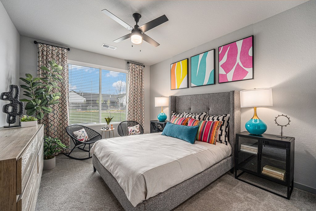 a bedroom with a bed and a ceiling fan
