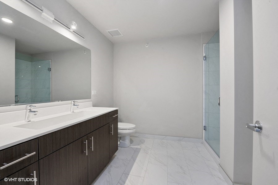 a bathroom with a sink and a toilet and a shower