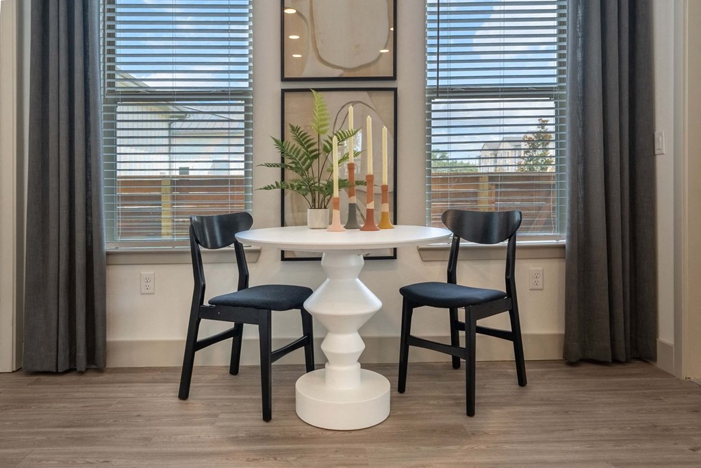 a dining room with a table and three chairs