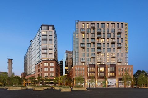 Two modern apartment buildings are situated next to each other.