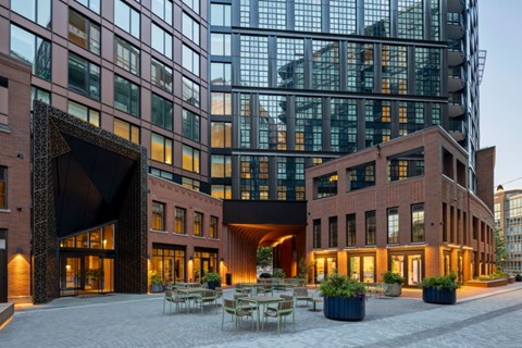 A modern building with a glass facade and a brick exterior.