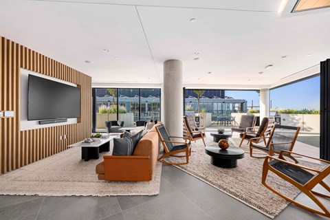 A modern living room with a flat screen TV and comfortable seating.