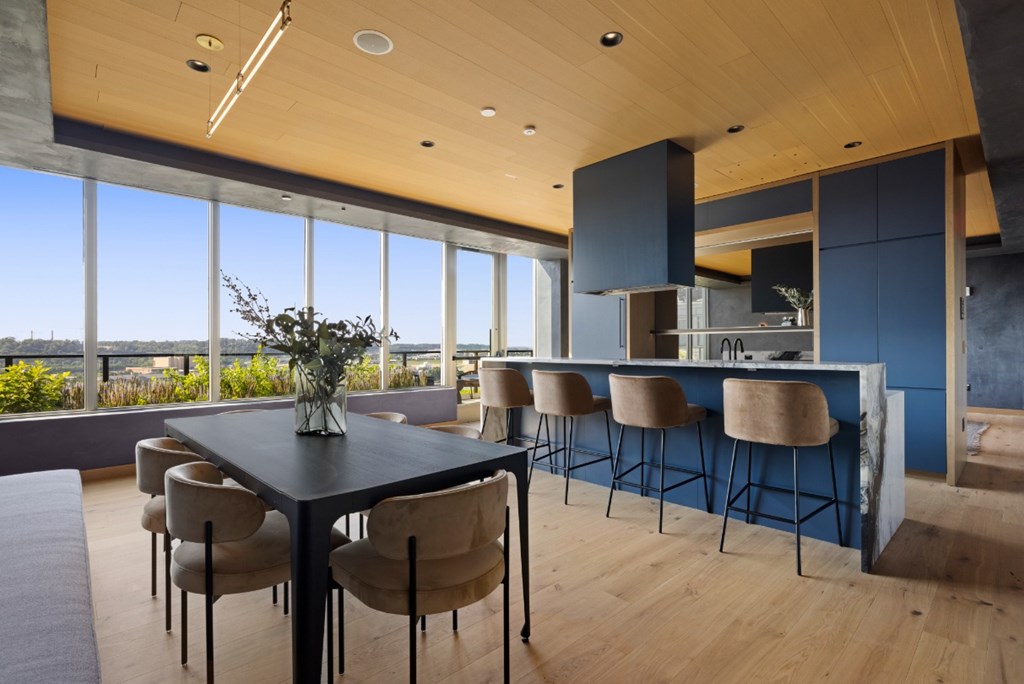 A modern dining room with a large table and chairs.