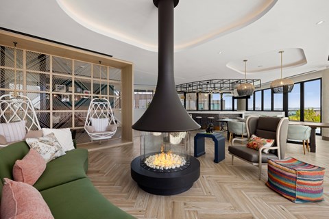 A modern living room with a fireplace and comfortable seating.