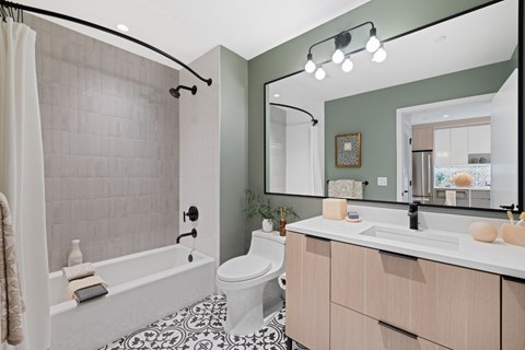 A bathroom with a white tub, toilet, and sink.