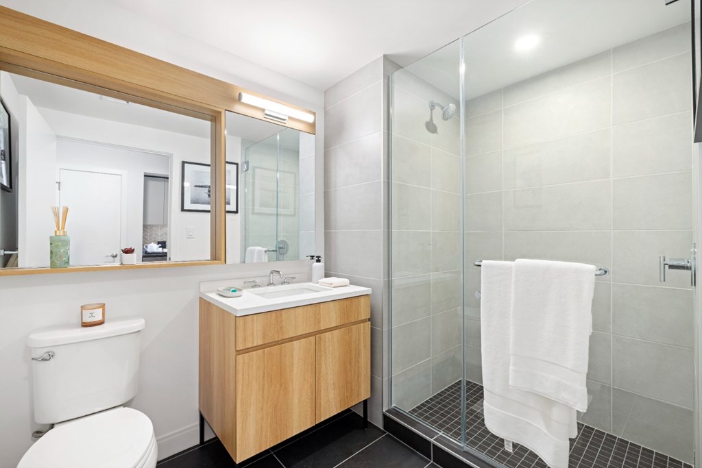 A white toilet sits next to a sink in a bathroom.
