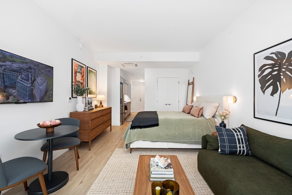 A living room with a green couch and a coffee table.