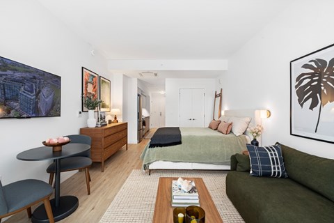 A living room with a green couch and a coffee table.