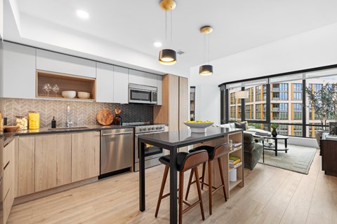 A modern kitchen with wooden cabinets and a large island.