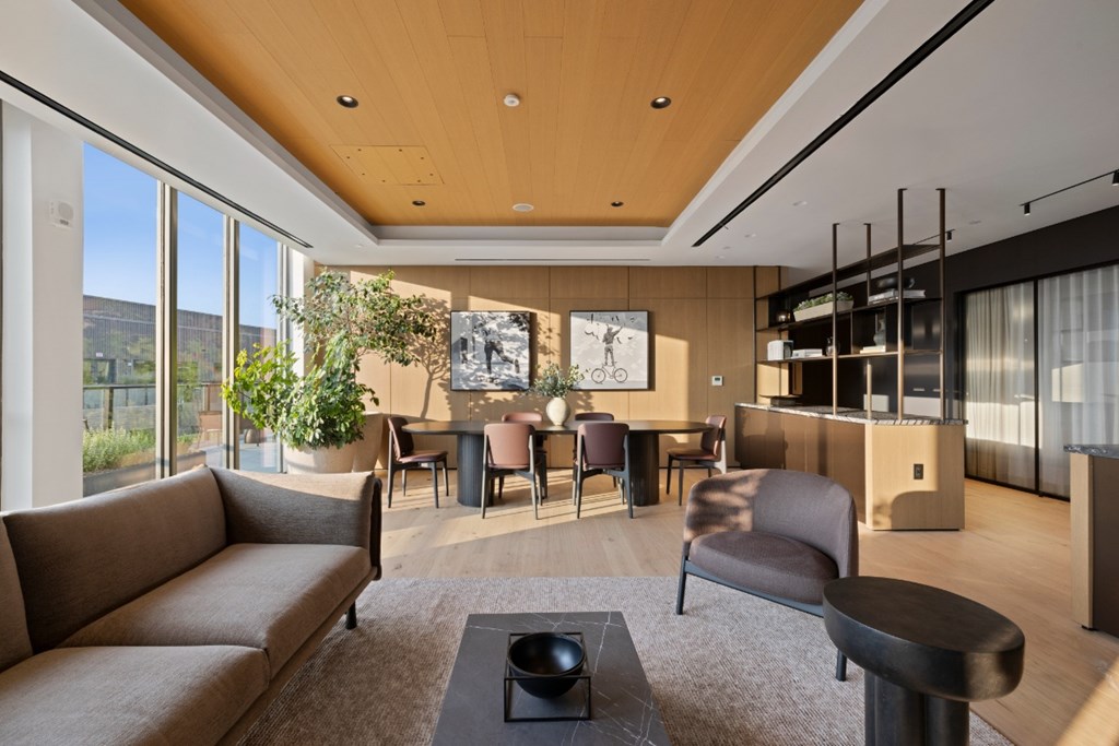 A modern living room with a brown sofa and a wooden coffee table.