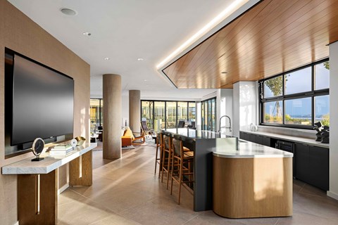 A modern kitchen with a large island and wooden cabinets.