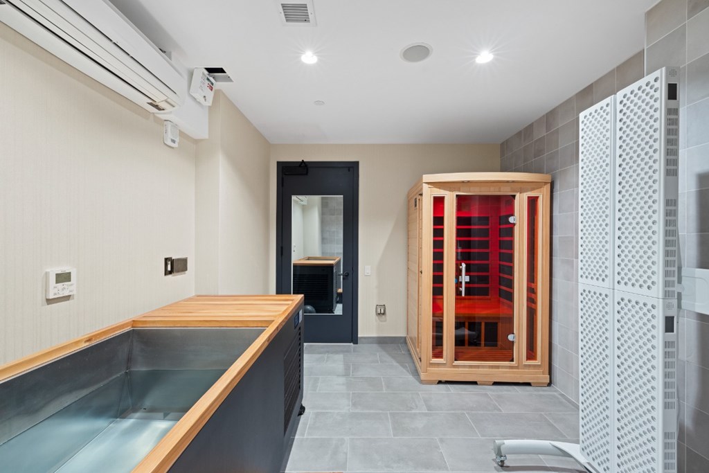 A modern kitchen with a wooden counter and a glass stove top.
