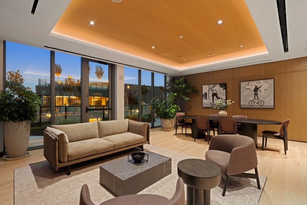 A living room with a couch, chairs, and a coffee table.