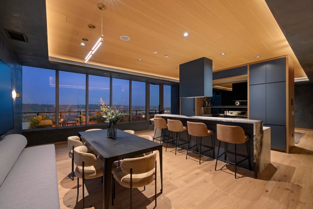 A modern dining room with a table and chairs.