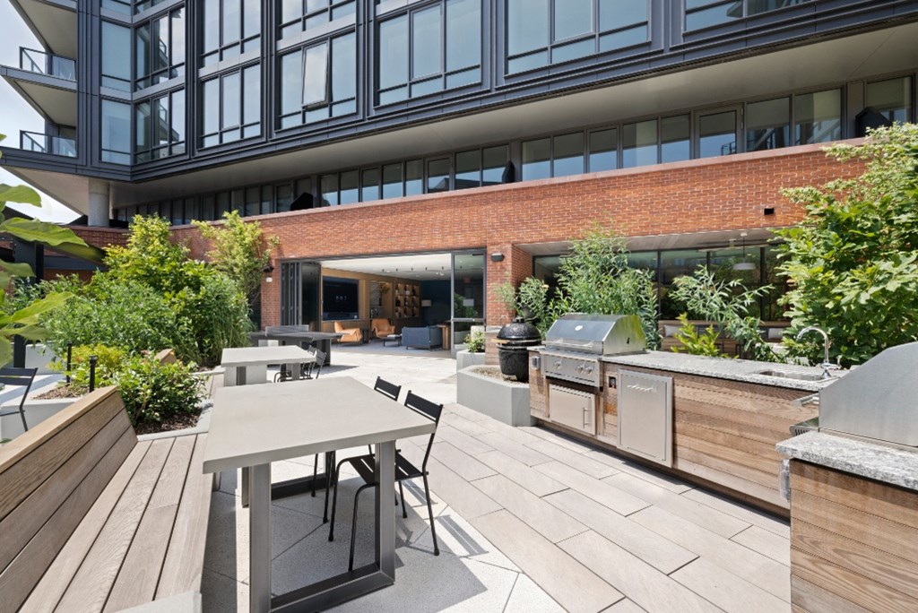 A modern outdoor seating area with a table and chairs.