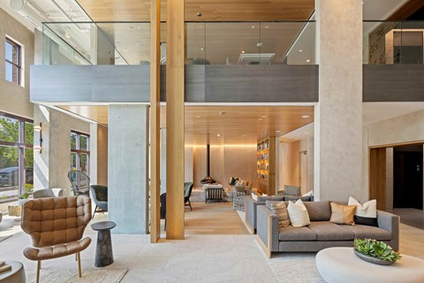 A modern living room with a glass ceiling and a brown armchair.