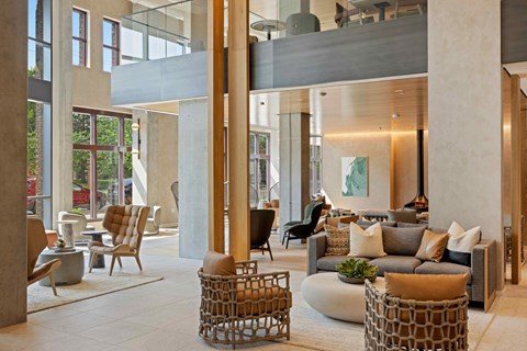 A modern living room with a large window and a fireplace.