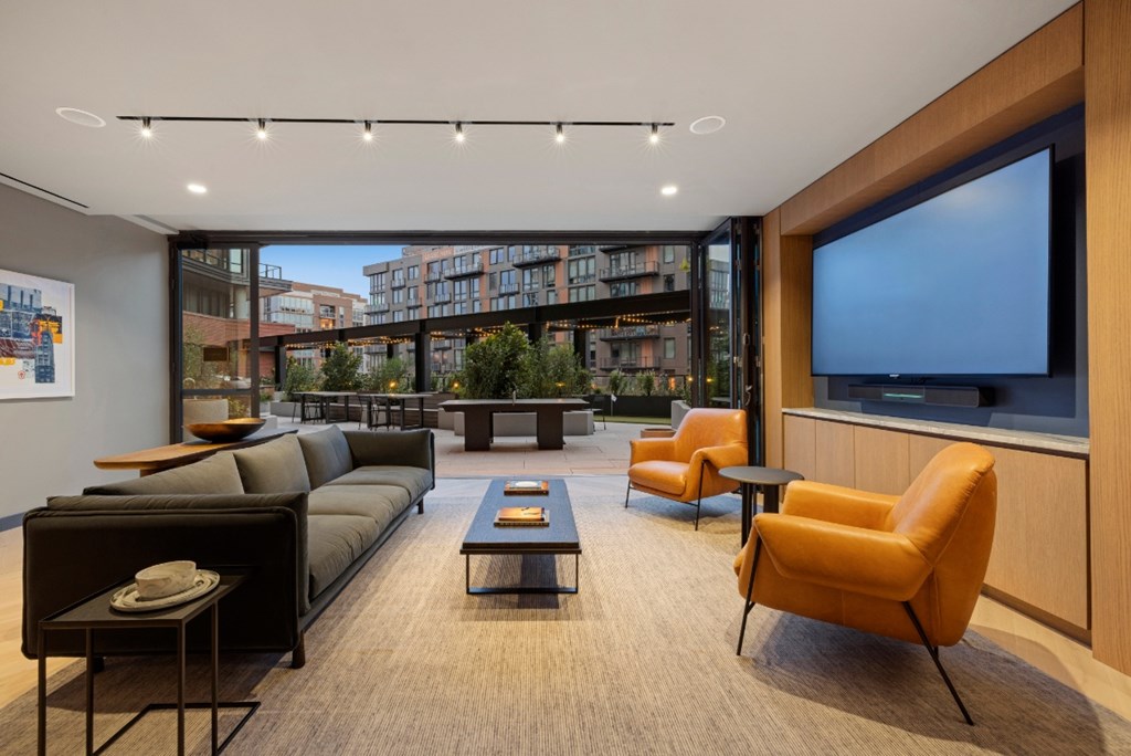 A modern living room with a large window overlooking a cityscape.