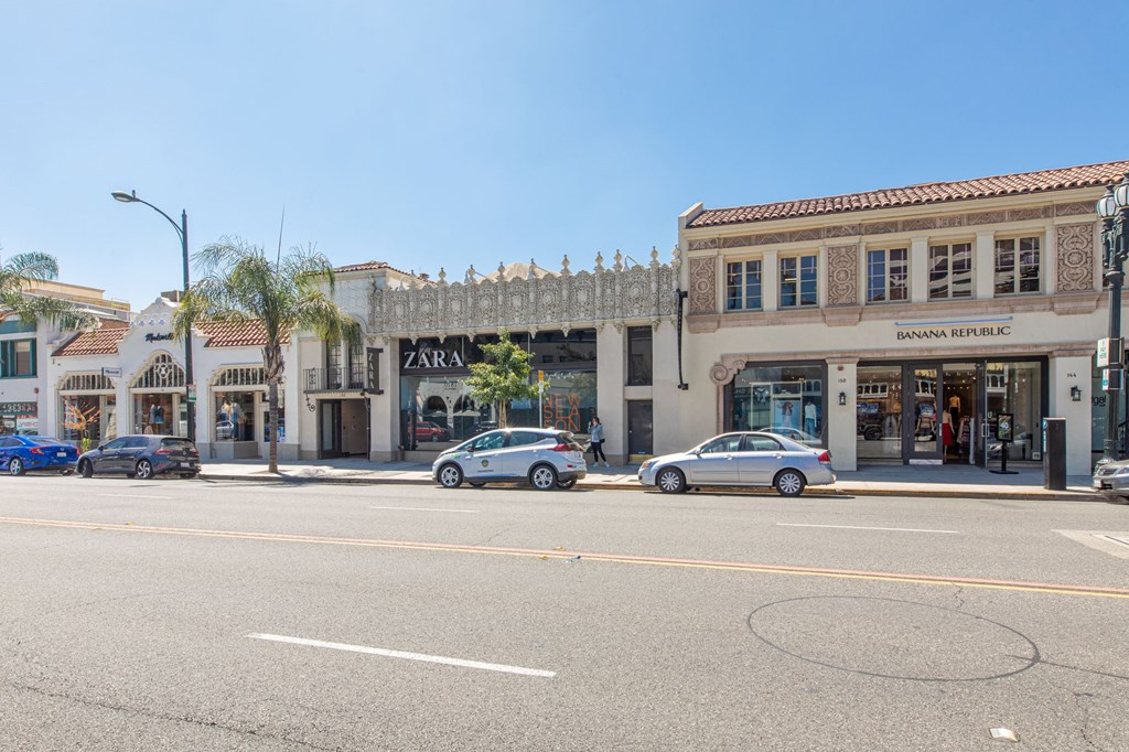 a city street with cars parked in front of a building