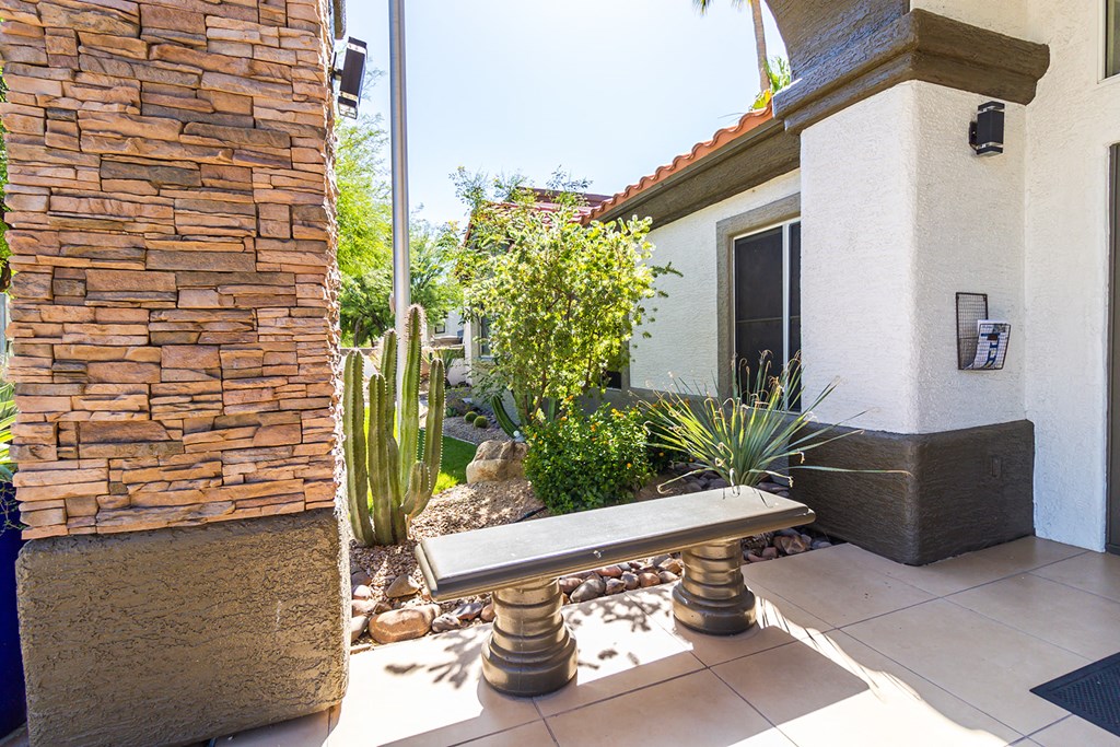 a bench on a patio in front of a house