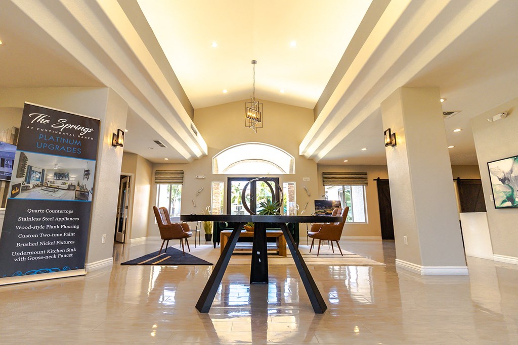 a dining area with a table and chairs